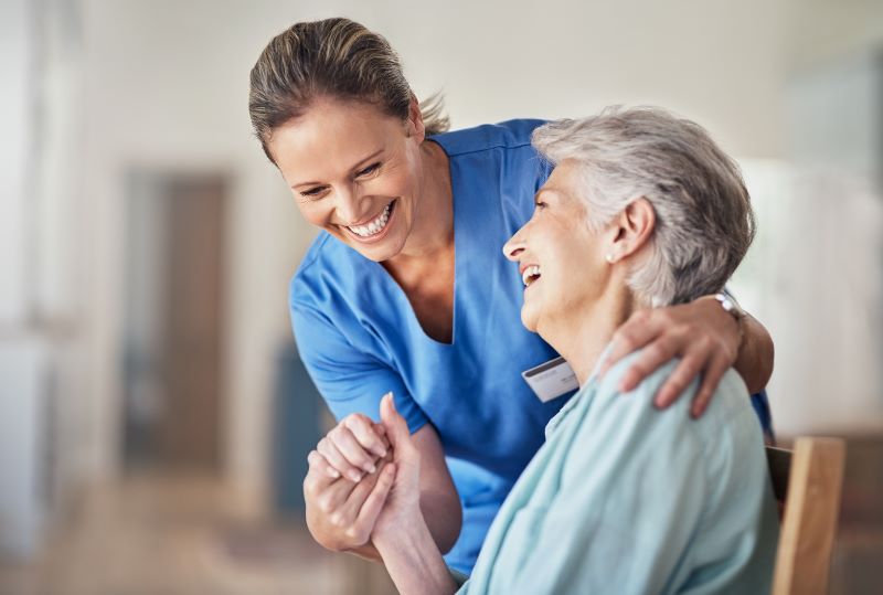Nurse laughing with a senior woman